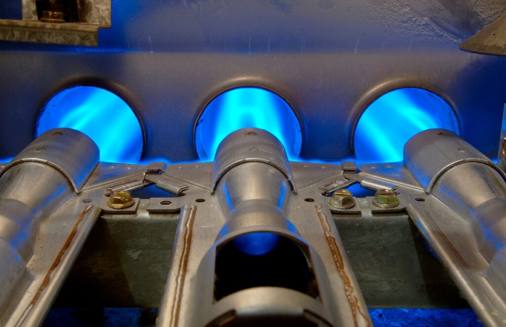 Inside a gas furnace. Focus = the top of the middle flange