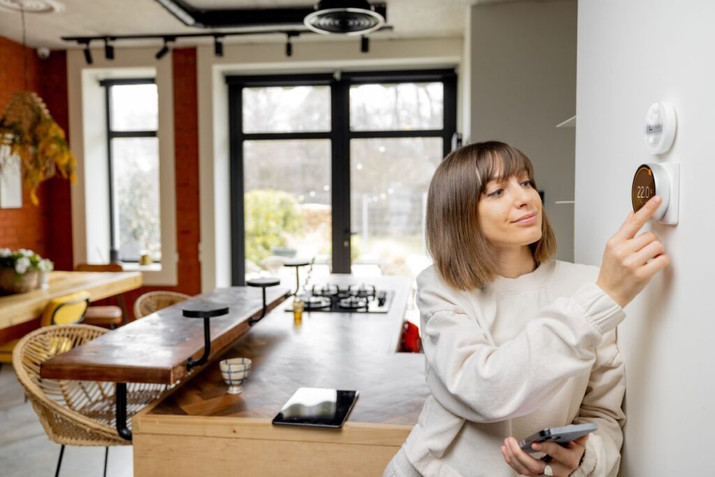 thermostat wiring woman adjusting temperature inside big comfortable home