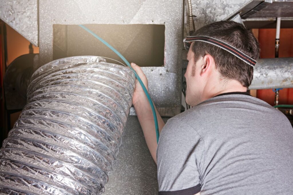 ventilation cleaner man at work with tool