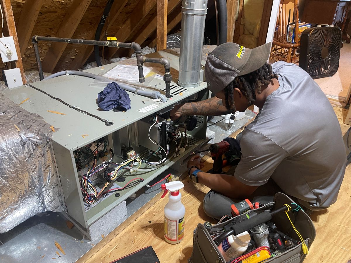 Panther HVAC technician working on AC maintenance
