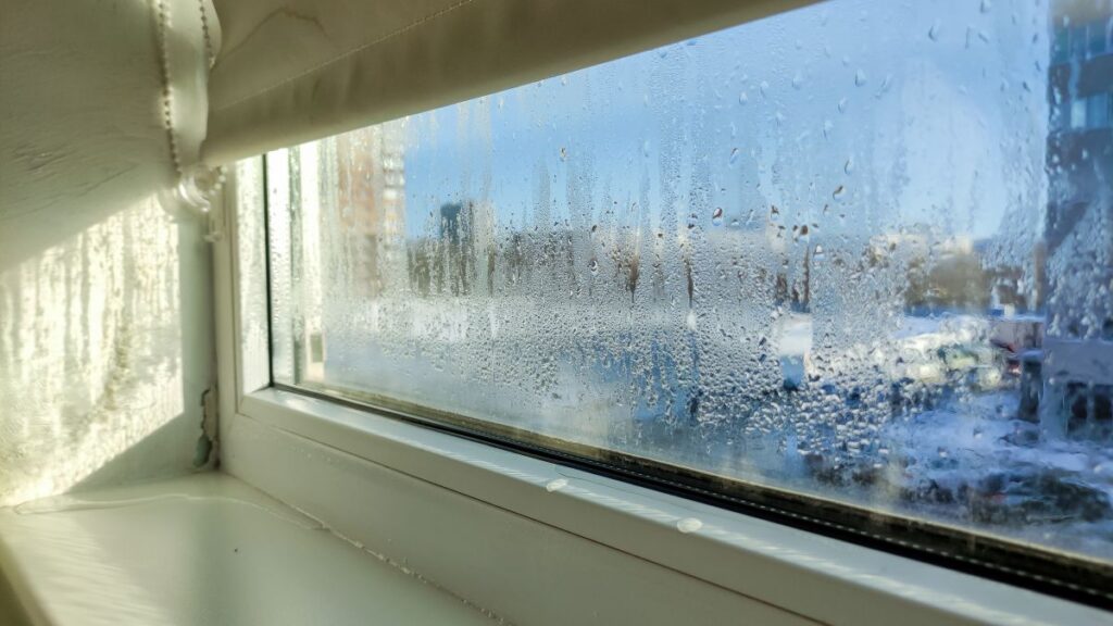 Drops of condensation on a poor-quality PVC window